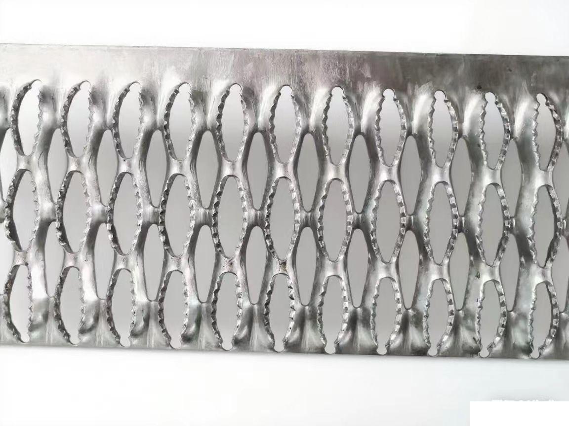 Serrated non-slip perforated metal grating for sidewalks and stair treads