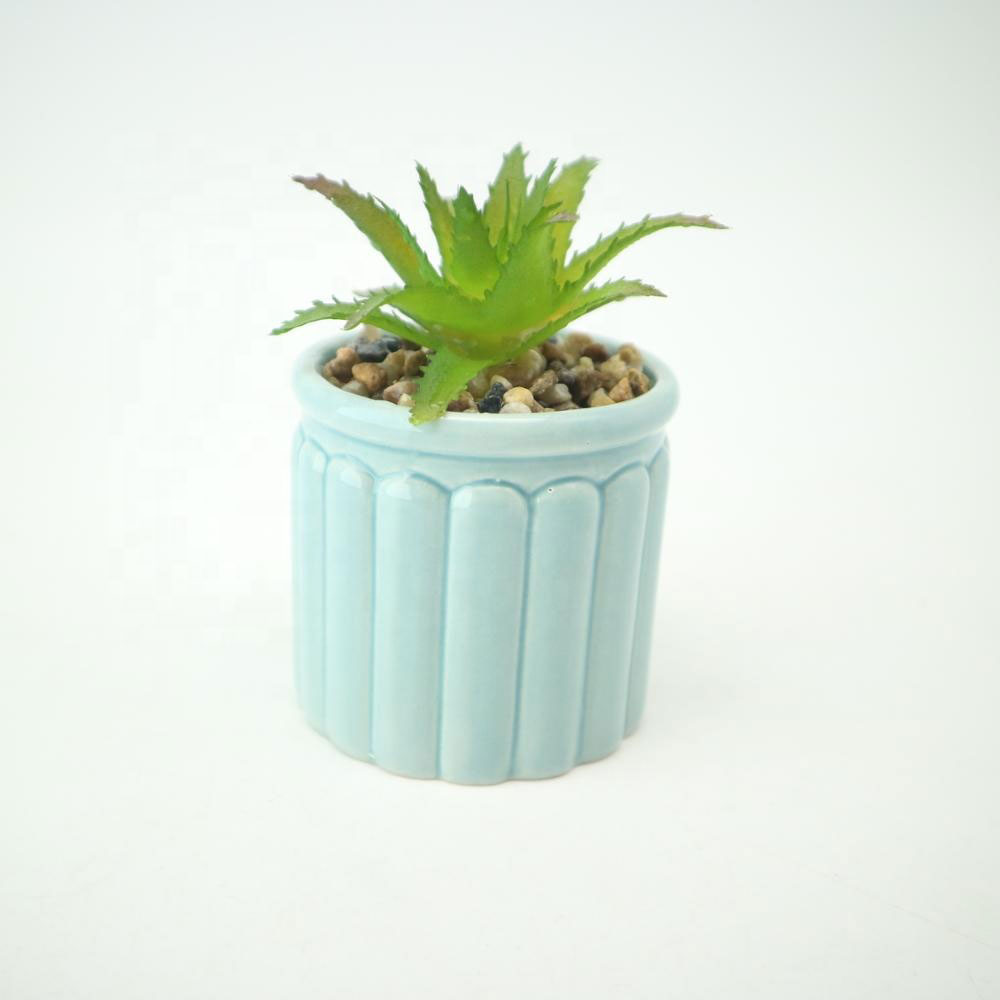Small Ceramic Pot with Natural Touch Faux Succulent potted with simulated soil.