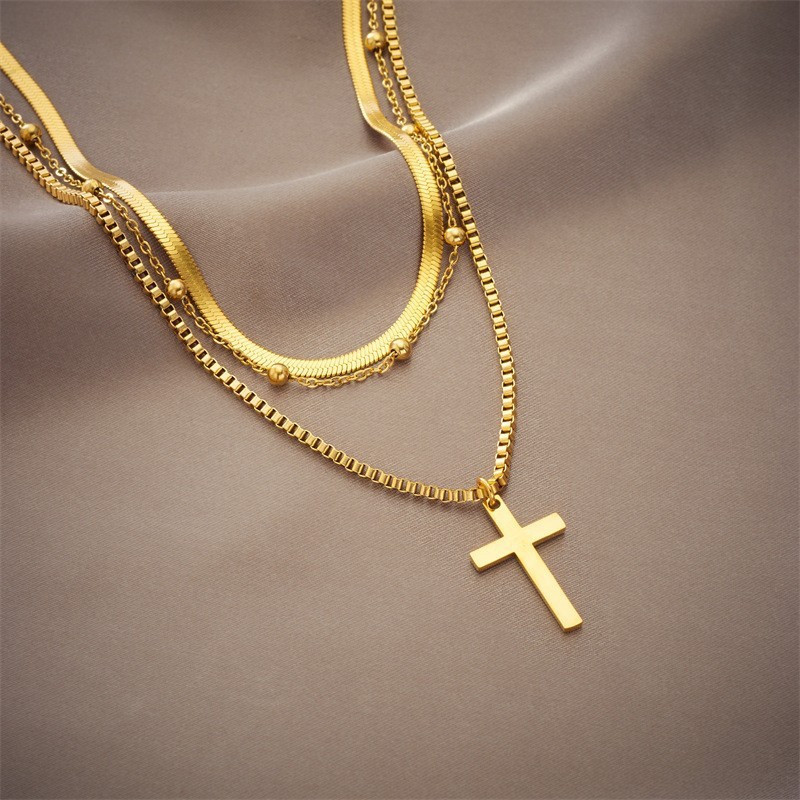 Layered Gold Titanium Steel Necklace with Cross Pendant and Gold Bead Accents
