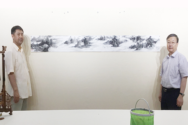 昌宇集团董事长李刚与辽宁省文联副主席喻国伟